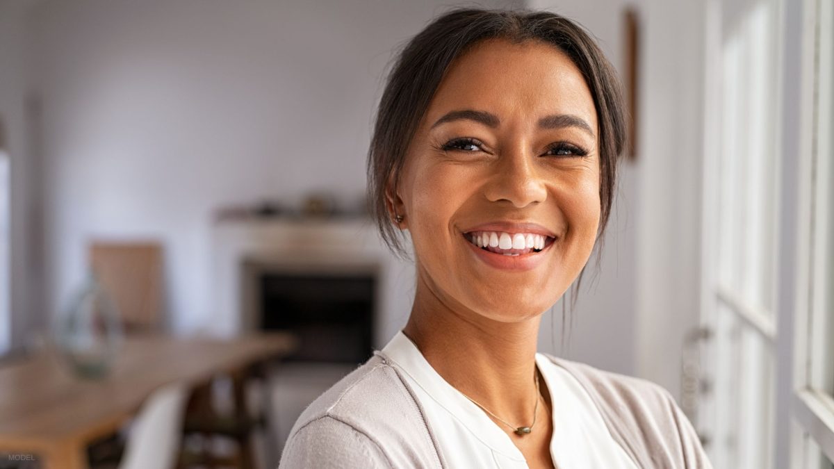 Woman smiling at the camera, enjoying her BOTOX results (MODEL)